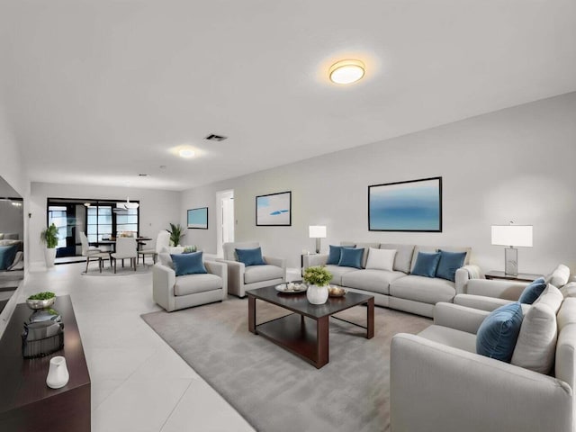 living area featuring visible vents and light tile patterned flooring