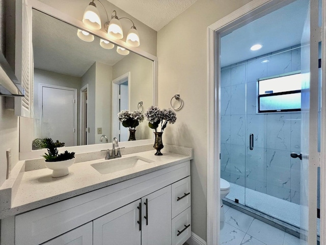 full bath featuring marble finish floor, a marble finish shower, toilet, vanity, and a textured ceiling