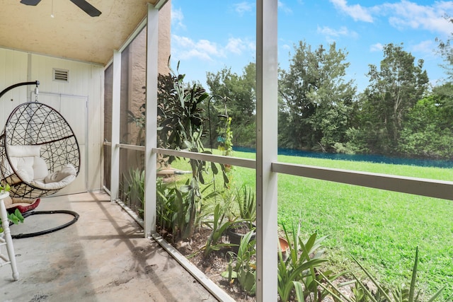 unfurnished sunroom featuring ceiling fan