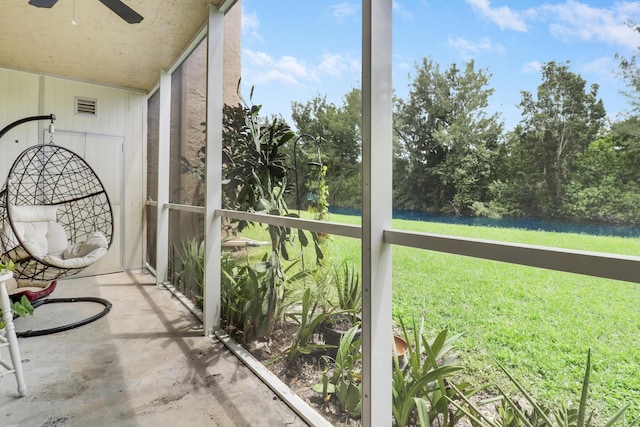 unfurnished sunroom featuring ceiling fan and a wealth of natural light