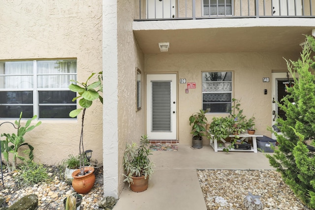 view of exterior entry featuring a balcony