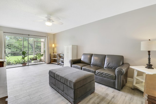 living room with light hardwood / wood-style floors and ceiling fan