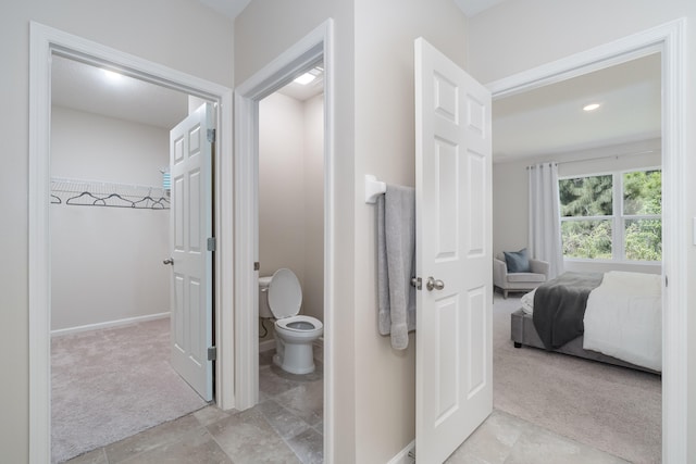 bathroom with toilet and tile patterned floors