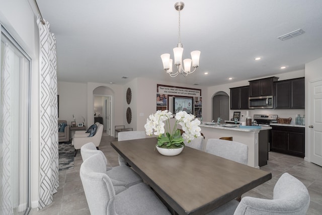 tiled dining space with a notable chandelier