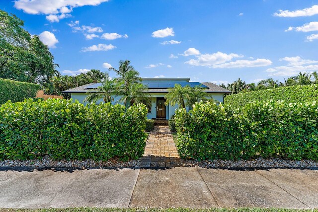 obstructed view of property featuring solar panels