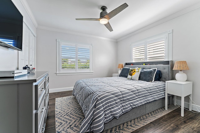 bedroom featuring crown molding, ceiling fan, dark wood-type flooring, and multiple windows