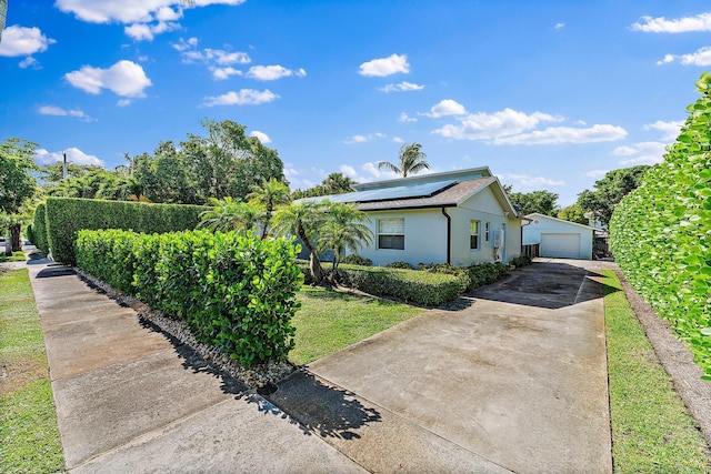 view of front of property with a garage and solar panels