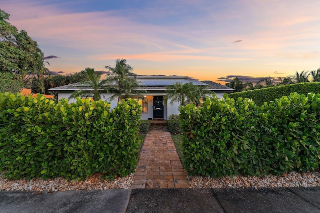 view of front of house featuring solar panels