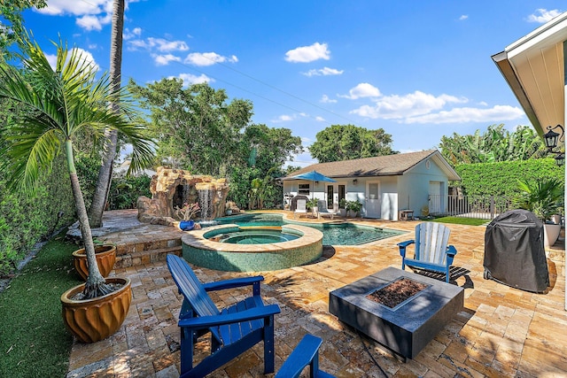 view of pool with an in ground hot tub, an outdoor structure, a patio, and an outdoor fire pit