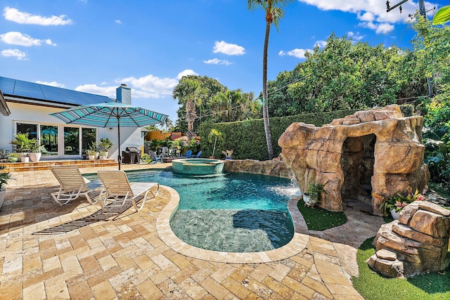 view of swimming pool featuring an in ground hot tub and a patio area