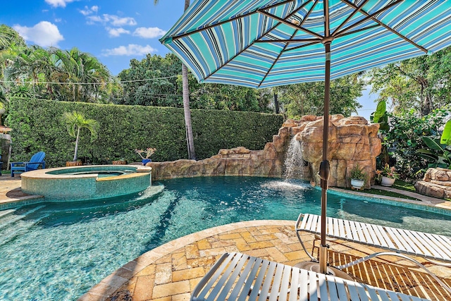 view of pool featuring a patio and an in ground hot tub