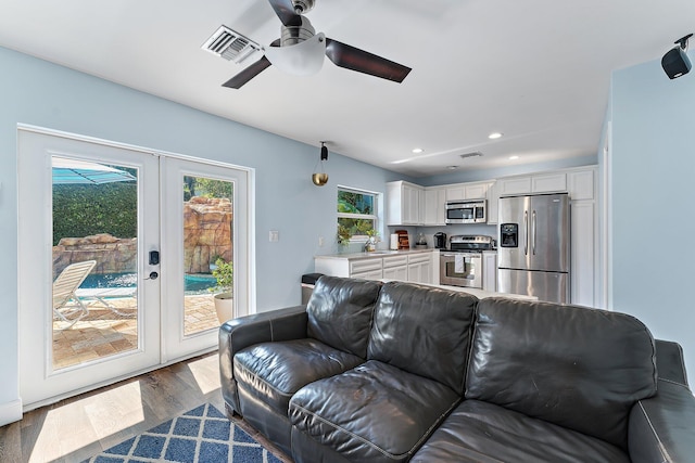 living room with dark hardwood / wood-style floors, sink, and french doors