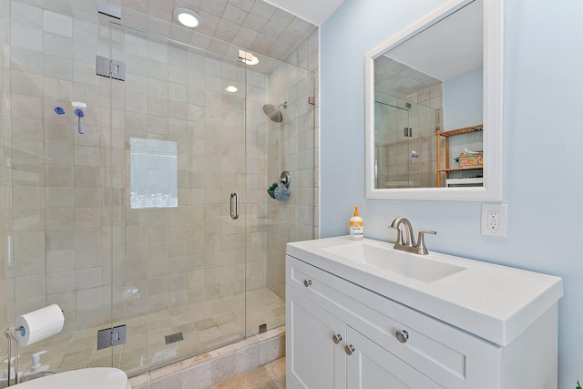 bathroom featuring walk in shower, vanity, and toilet