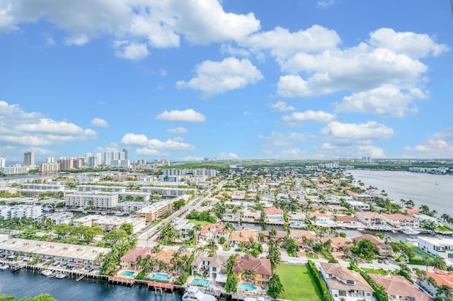 birds eye view of property featuring a water view and a city view