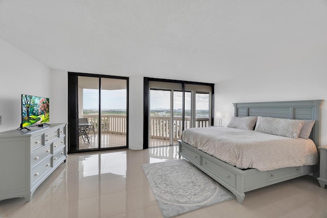 bedroom with access to exterior, light tile patterned floors, and floor to ceiling windows