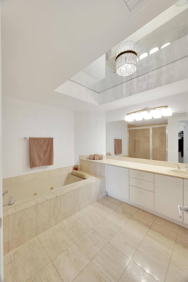 full bath featuring tile patterned flooring, a shower stall, a tub with jets, and vanity