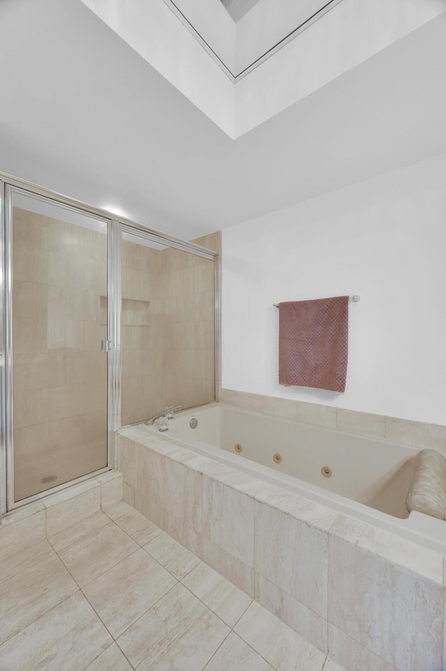 bathroom featuring a shower stall, a whirlpool tub, and tile patterned floors