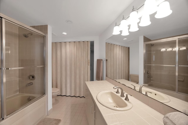 bathroom with bath / shower combo with glass door, vanity, toilet, and tile patterned floors