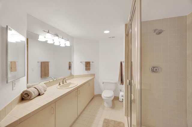 bathroom with toilet, a stall shower, baseboards, and vanity