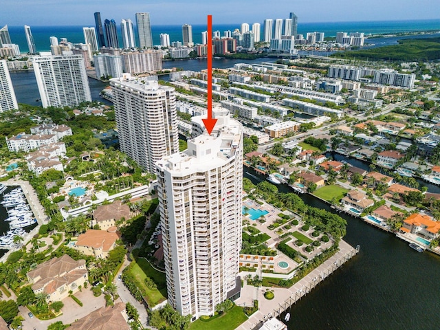 birds eye view of property with a view of city and a water view