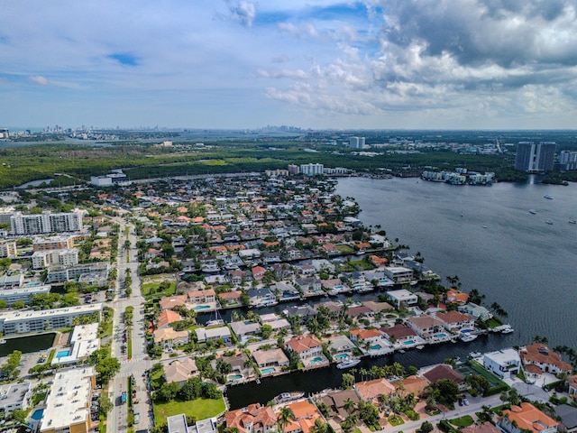 birds eye view of property with a water view and a city view