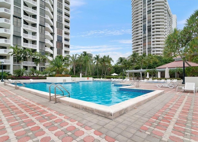 pool with a patio and a pergola