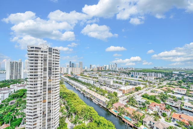 birds eye view of property with a water view and a city view