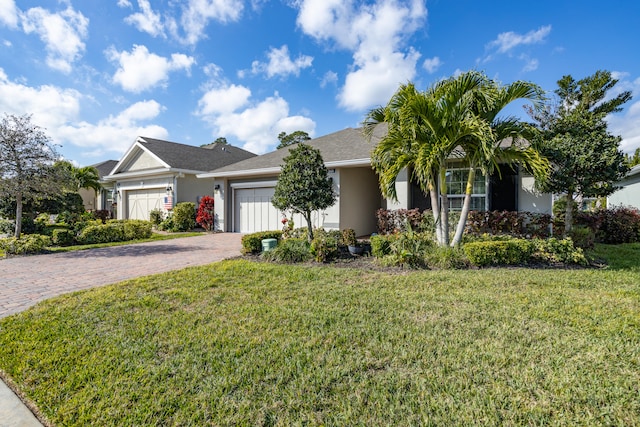 ranch-style home with a garage and a front lawn