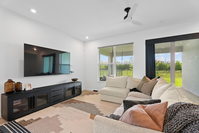 living room with ceiling fan, baseboards, light wood-style flooring, and recessed lighting