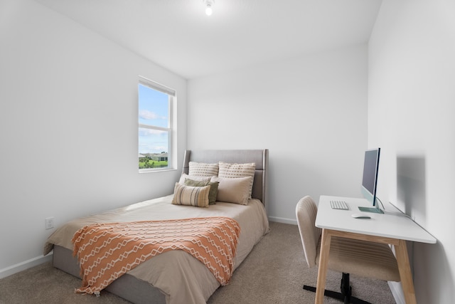 bedroom featuring light carpet and baseboards