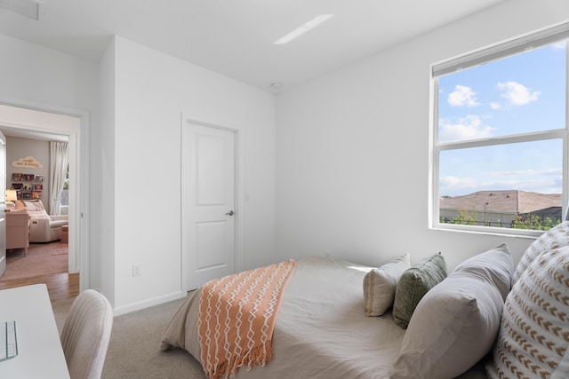 bedroom with carpet flooring, visible vents, and baseboards