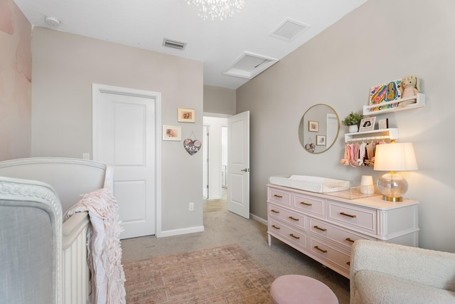 bedroom with visible vents, baseboards, attic access, and light colored carpet