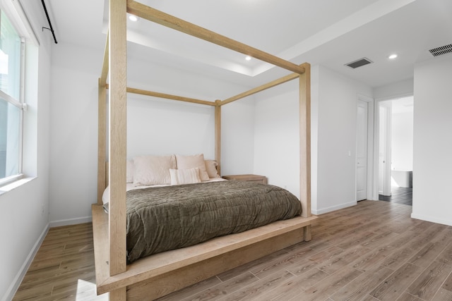 bedroom featuring visible vents, wood finished floors, and recessed lighting