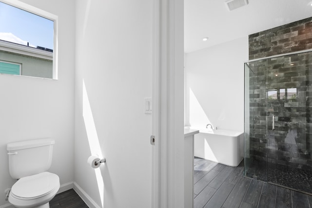 bathroom featuring a stall shower, visible vents, and wood finished floors