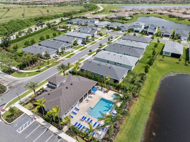 bird's eye view with a water view and a residential view