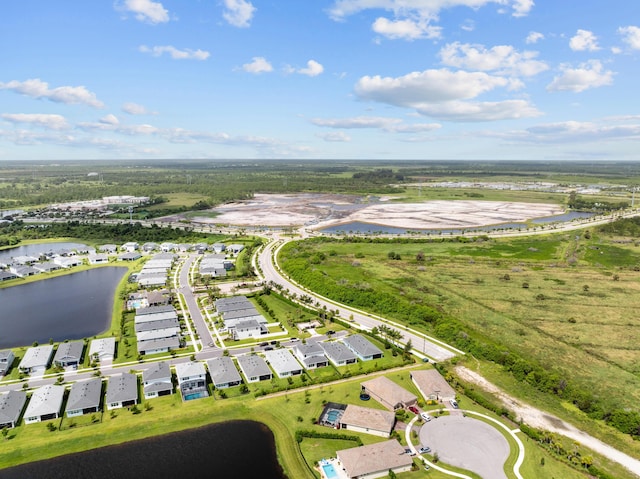 drone / aerial view featuring a water view and a residential view