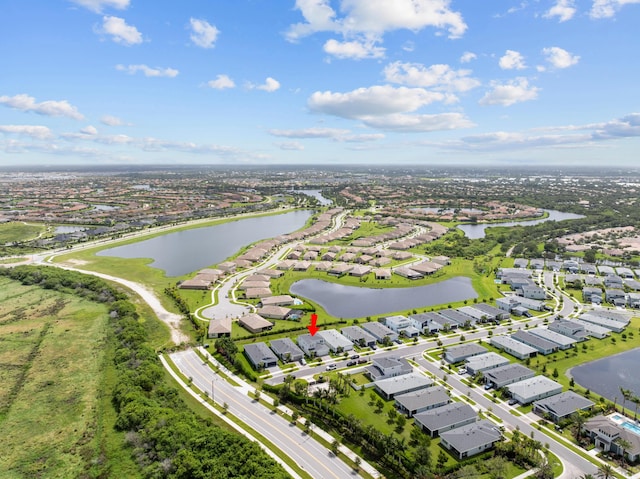 birds eye view of property with a water view and a residential view