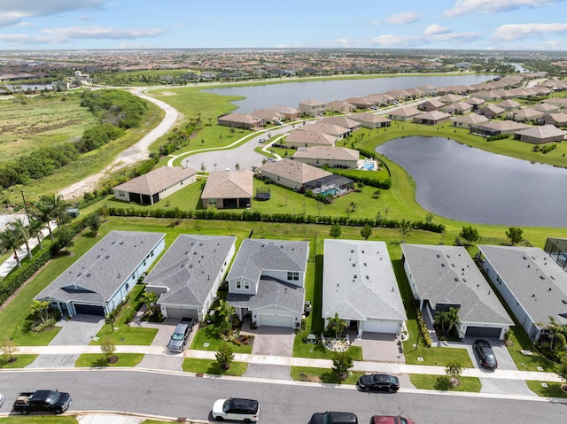 drone / aerial view with a water view and a residential view