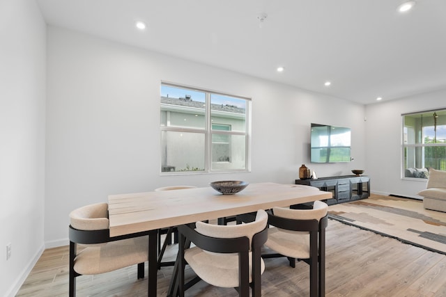 dining area featuring a healthy amount of sunlight, light wood-style flooring, baseboards, and recessed lighting