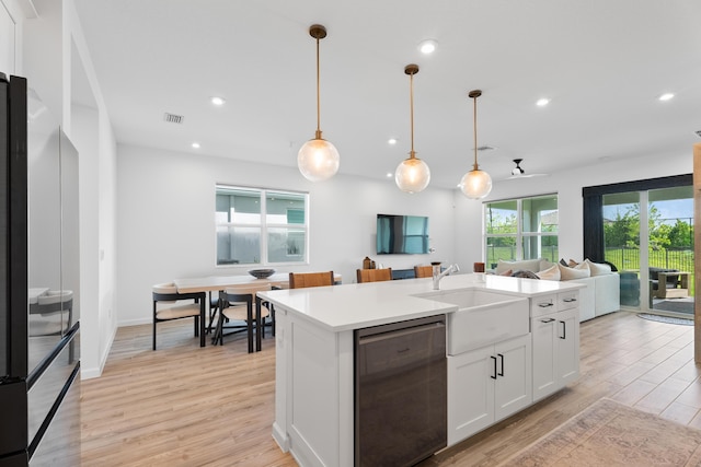 kitchen featuring visible vents, white cabinetry, open floor plan, light countertops, and dishwasher