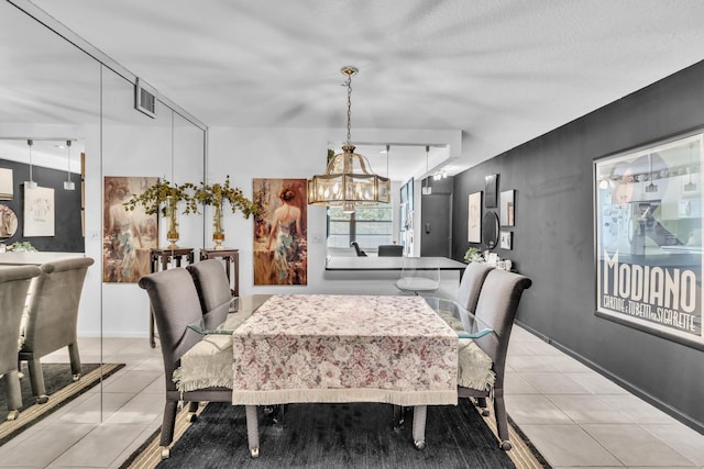 dining space with a notable chandelier and light tile patterned flooring