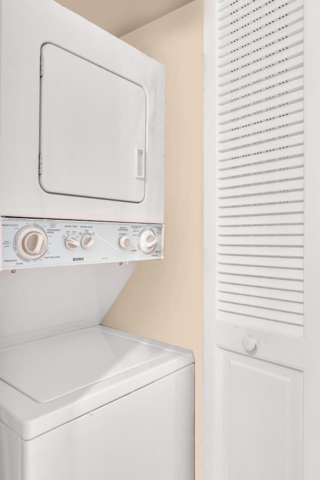 laundry area with stacked washer and dryer