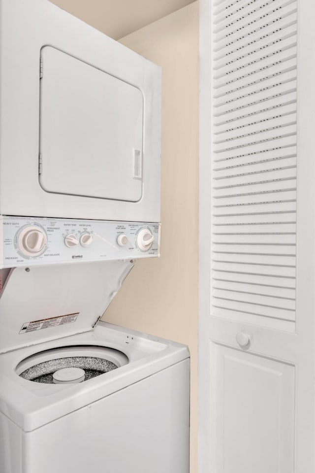 washroom with stacked washer and clothes dryer