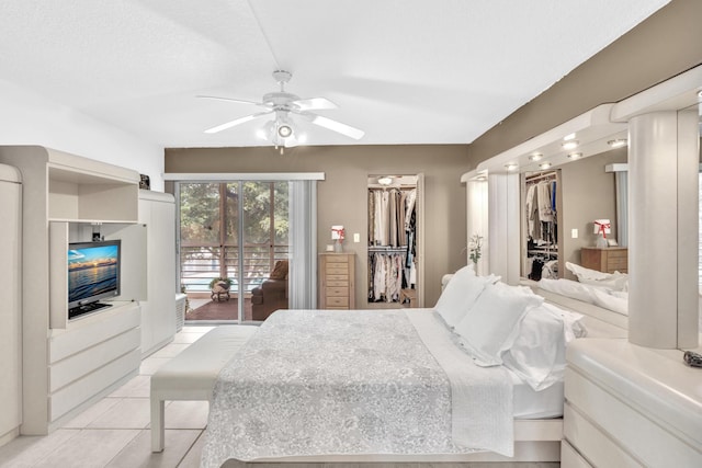 tiled bedroom featuring ceiling fan, a spacious closet, and access to outside