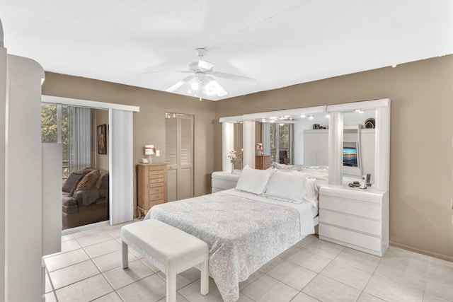 tiled bedroom with ceiling fan and a closet