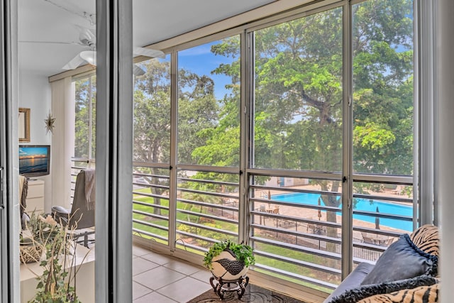 sunroom / solarium featuring ceiling fan