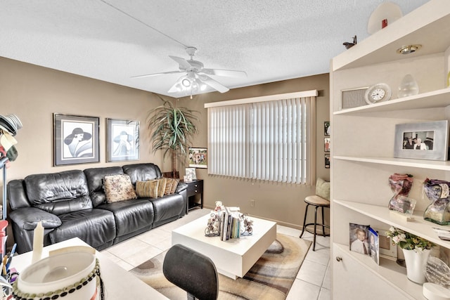 tiled living room featuring ceiling fan and a textured ceiling