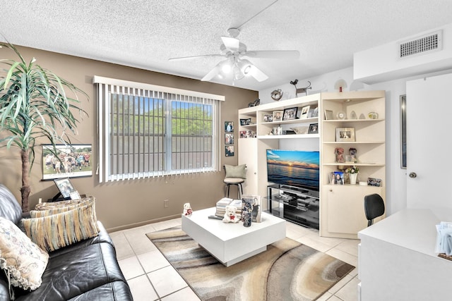 tiled living room featuring a textured ceiling and ceiling fan