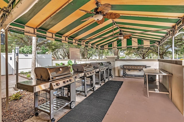 view of patio featuring area for grilling, ceiling fan, and a grill