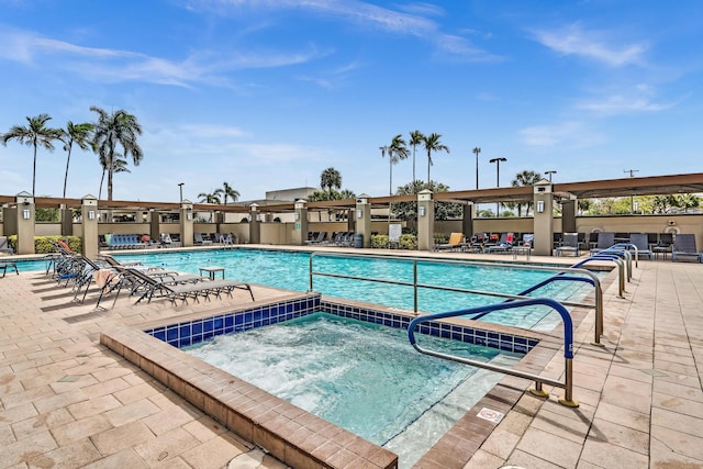 view of pool with a community hot tub and a patio area